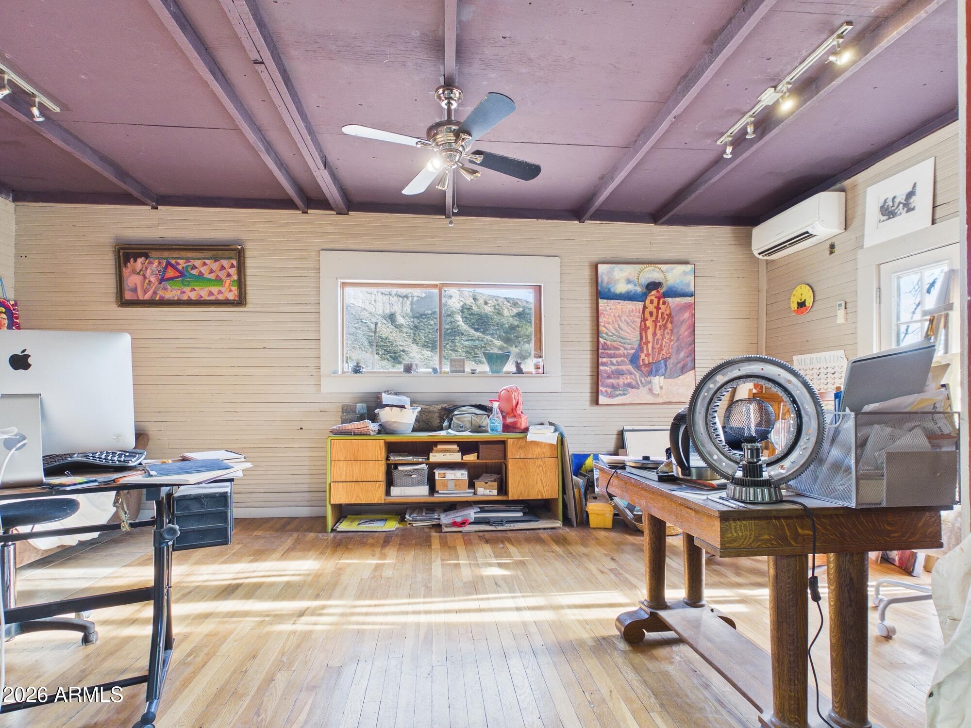 198 4th Street Clifton, AZ 85533 - Photo 27 of 30 a living room with lots of furniture and paintings on the wall