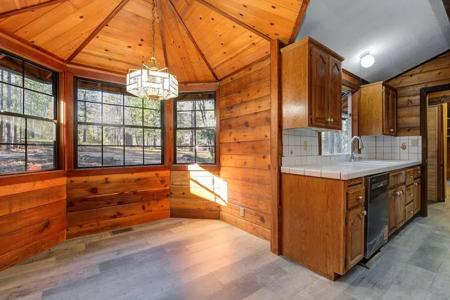 a kitchen that has a sink a stove and a wooden floor