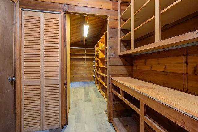 a view of empty room with wooden floor and fireplace