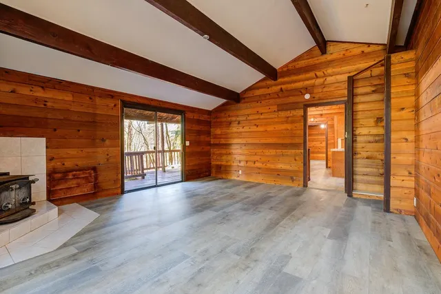 a bathroom with a granite countertop toilet a sink and shower