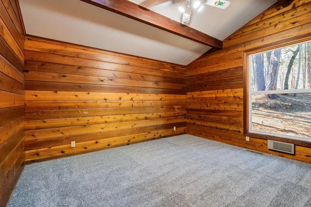 a view of an empty room with a fireplace