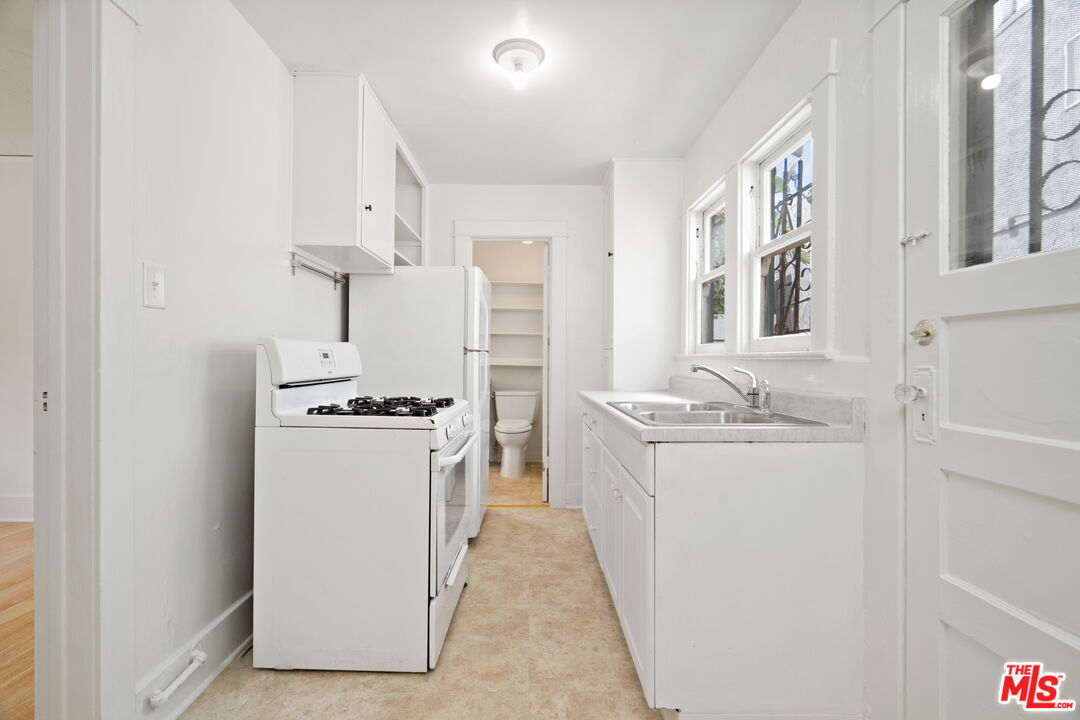 1747 9th Street Santa Monica, CA 90404 - Photo 15 of 24 a kitchen with a sink stove and refrigerator