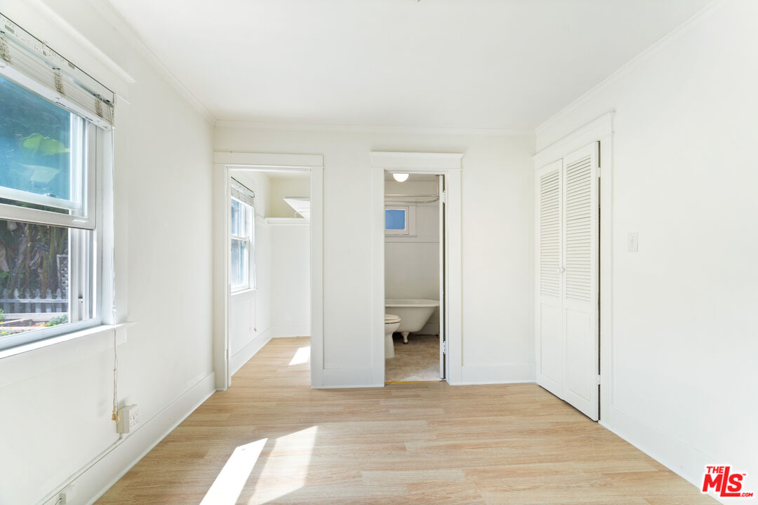 1747 9th Street Santa Monica, CA 90404 - Photo 18 of 24 a view of an empty room with wooden floor and a window
