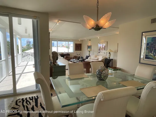 a dining room with furniture a chandelier and window