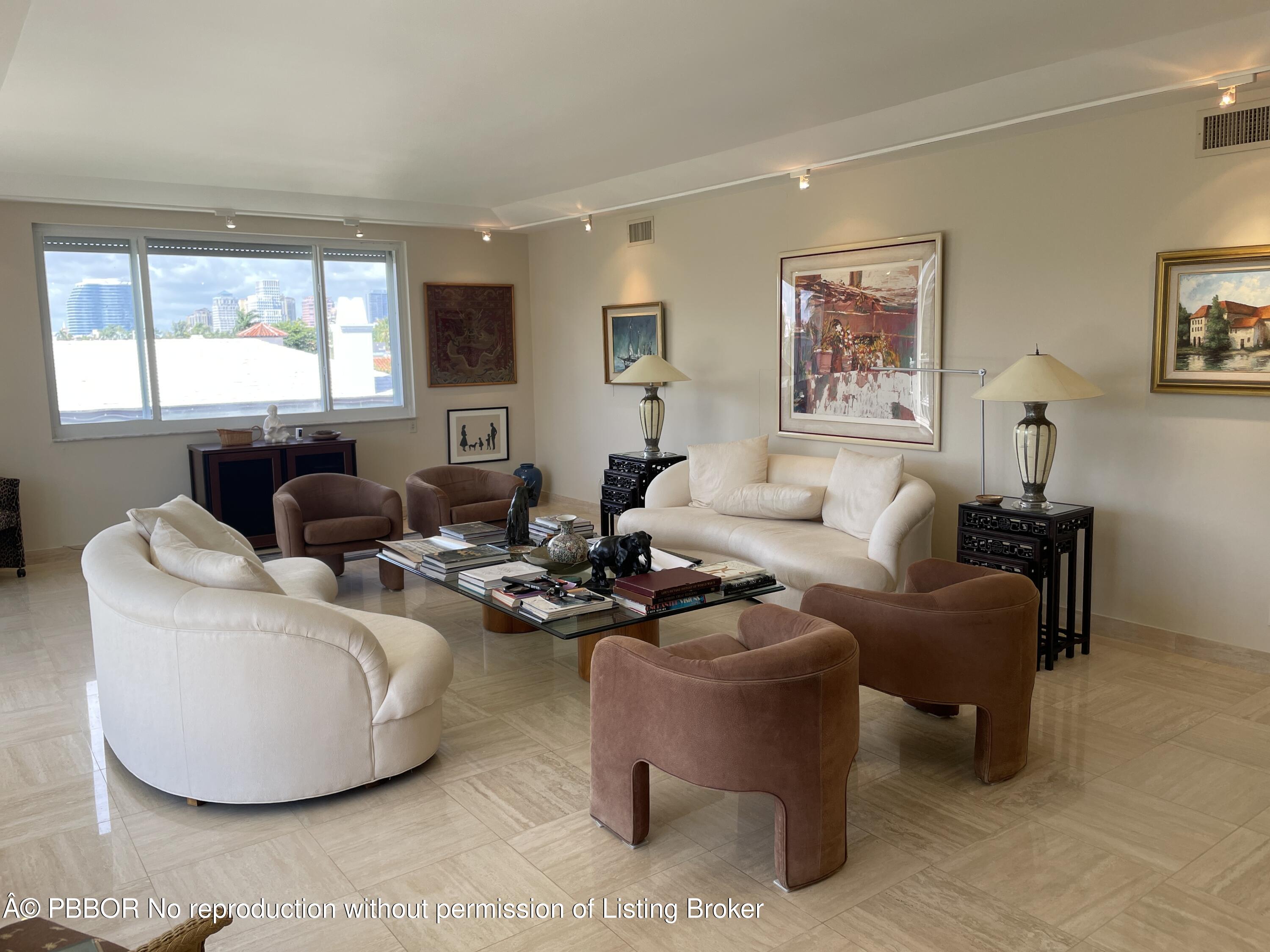 145 Peruvian Avenue, Unit 3010 Palm Beach, FL 33480 - Photo 6 of 18 a living room with furniture a large window and a flat screen tv