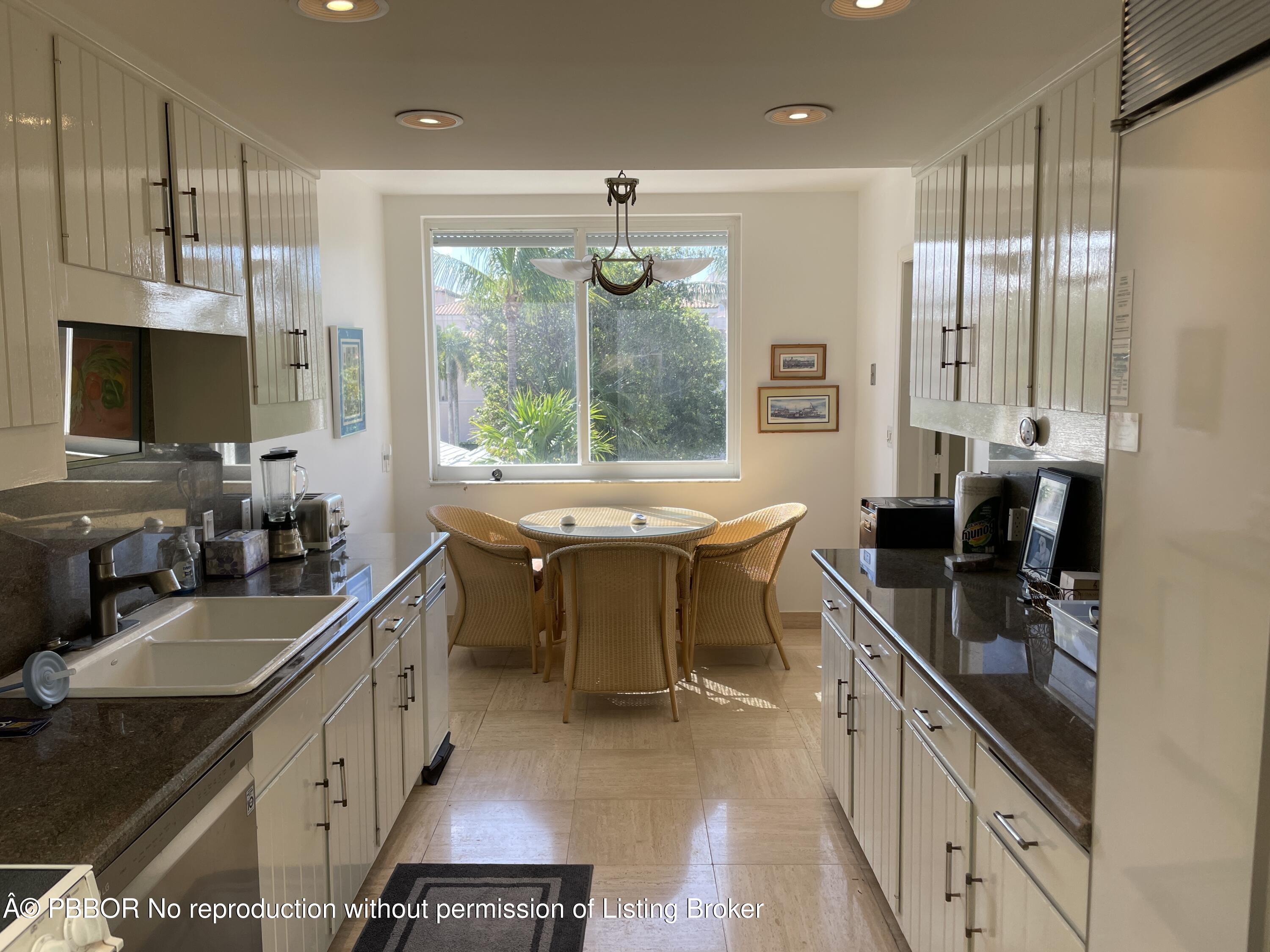 145 Peruvian Avenue, Unit 3010 Palm Beach, FL 33480 - Photo 8 of 18 a kitchen with sink stove and cabinets