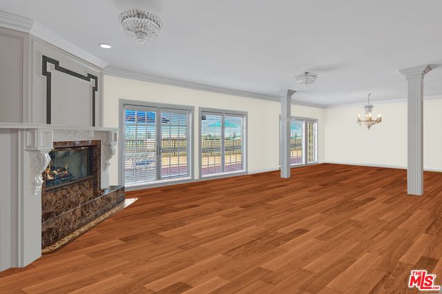 a big room with wooden floor and a fireplace