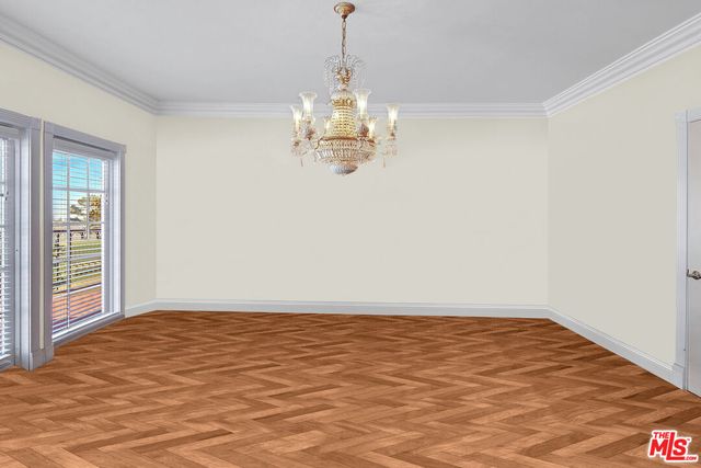 a big room with chandelier fan and windows