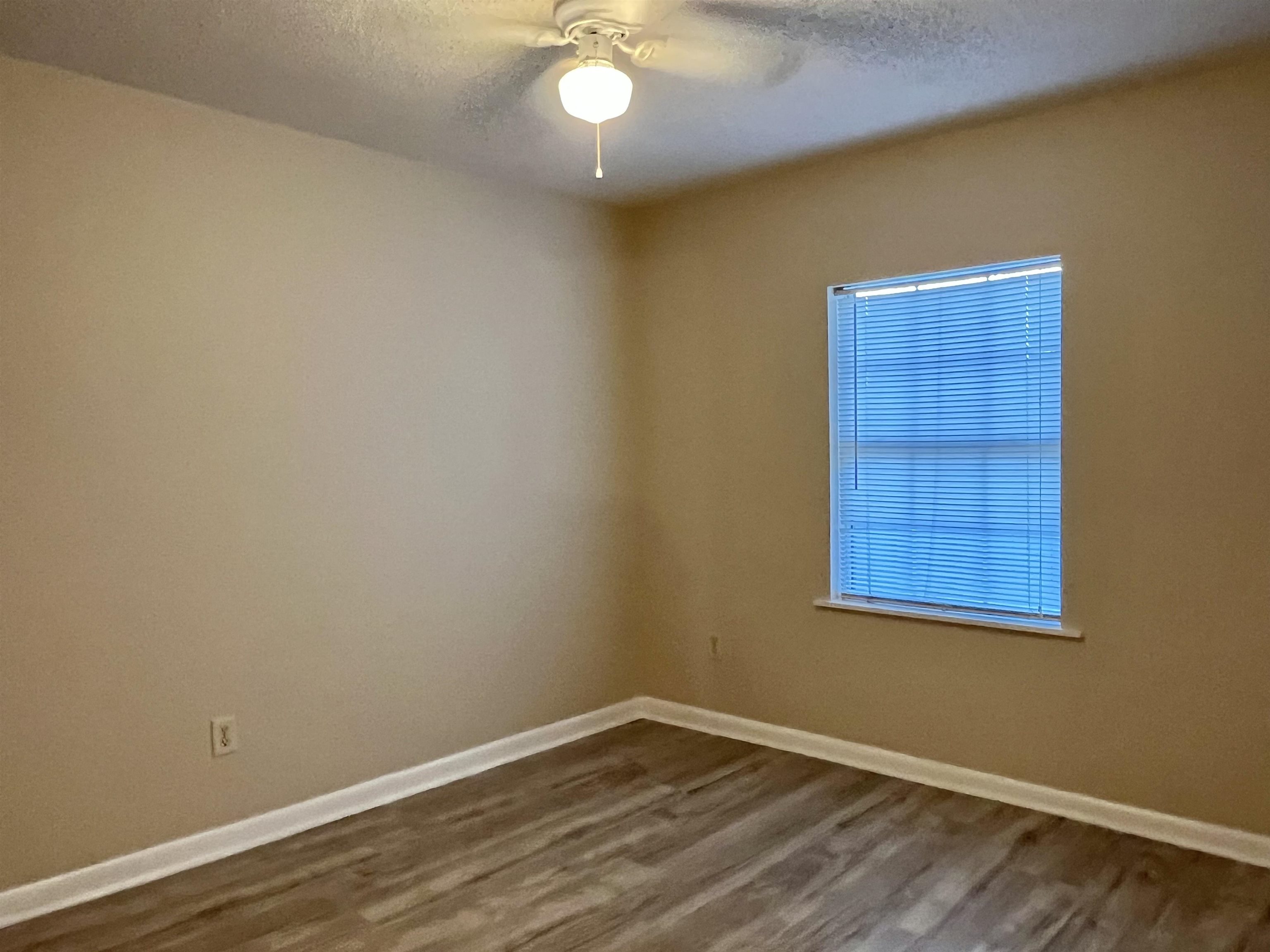 33 Evergreen Avenue, Unit B St. Augustine, FL 32084 - Photo 9 of 13 a view of an empty room with wooden floor and a window
