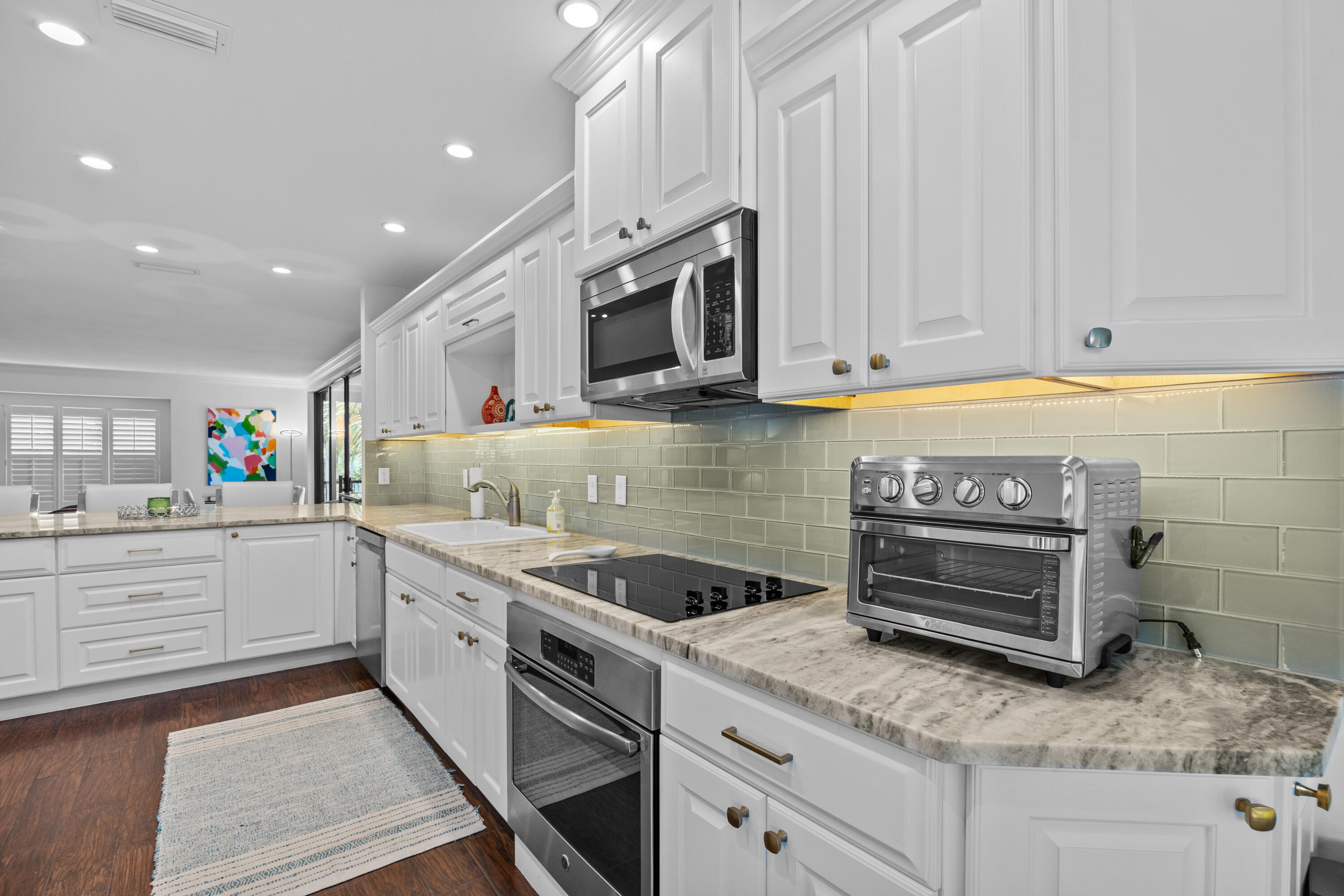 13254 Polo Club Road, Unit C204 Wellington, FL 33414 - Photo 6 of 29 a kitchen with stainless steel appliances granite countertop a sink and a stove