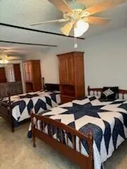 a bedroom with bed and a chandelier