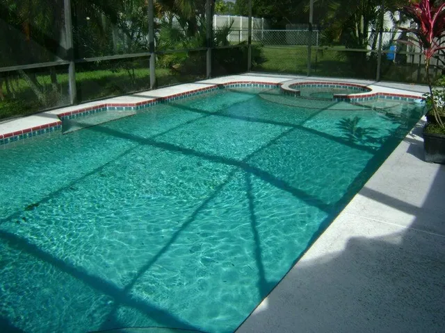 a view of swimming pool with a yard