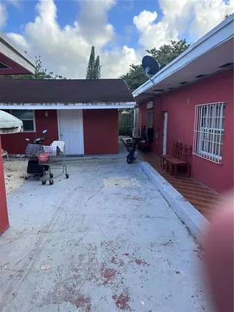 a view of a house with a patio and a fire pit