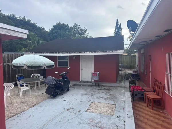 a view of a patio with table and chairs