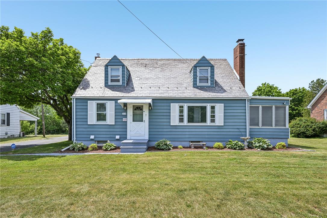 4065 Airport Road Allentown, PA 18109 - Photo 2 of 28 A charming blue home with white accents, a gray shingle roof, and a neatly manicured lawn.