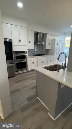 a kitchen with granite countertop a sink and cabinets