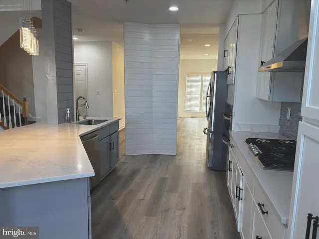 a kitchen with a sink stove and refrigerator