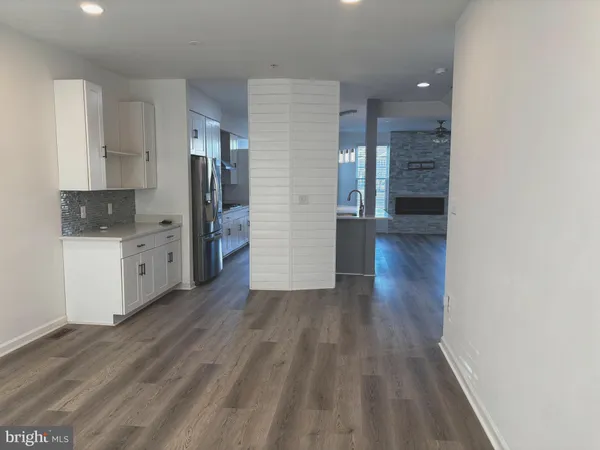 a view of a kitchen with wooden floor and a sink