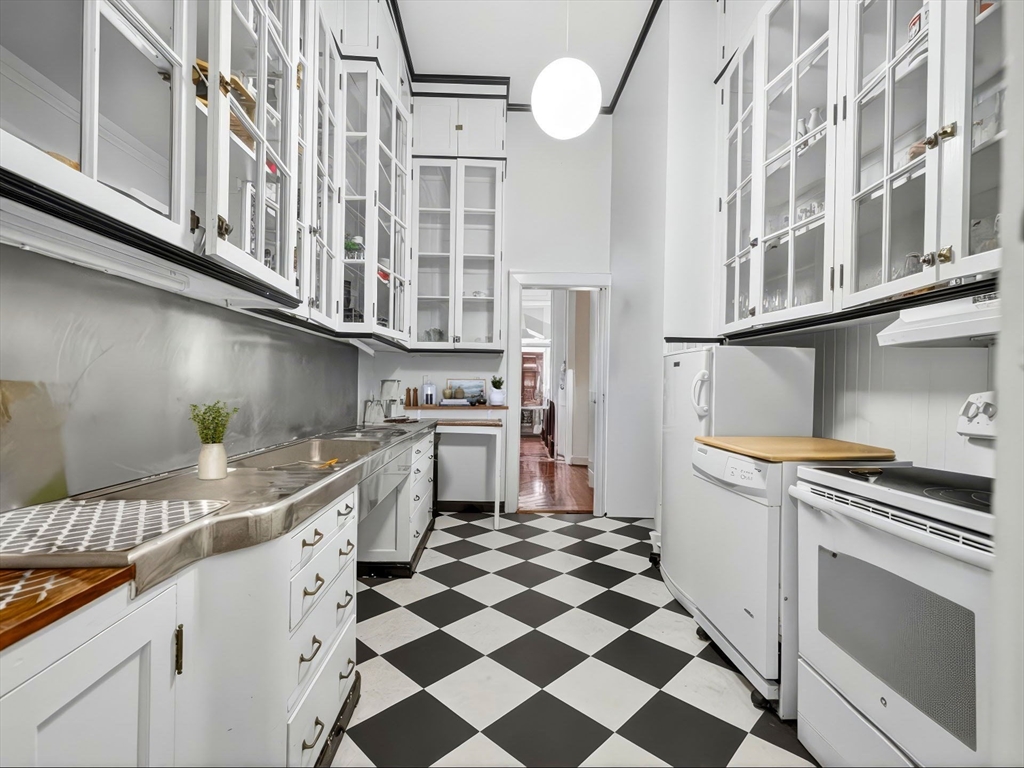 93 Beacon Street, Unit 5 Boston, MA 02108 - Photo 6 of 10 a kitchen with stainless steel appliances granite countertop a sink and a stove