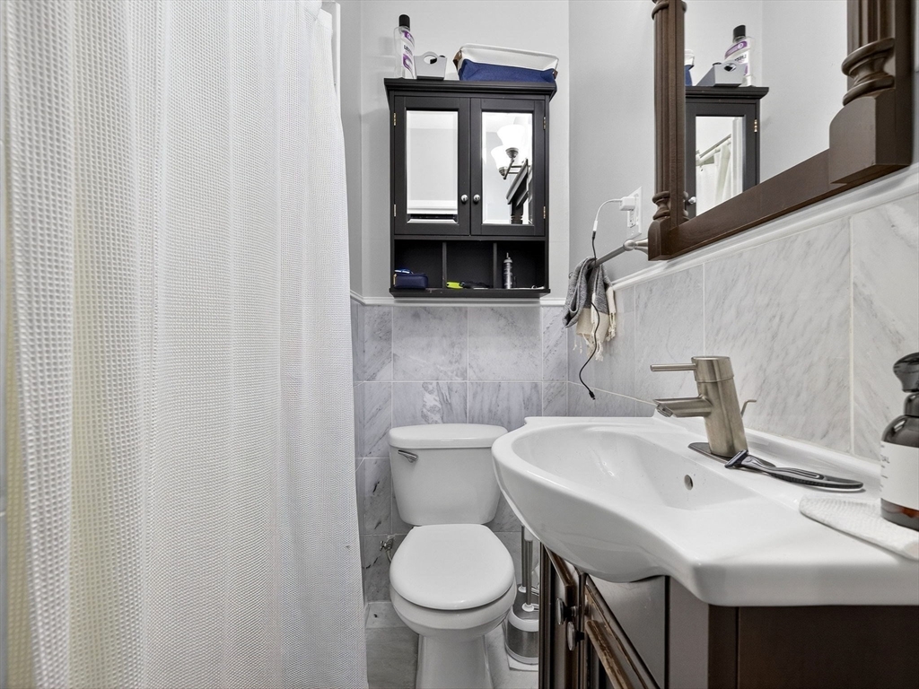 93 Beacon Street, Unit 5 Boston, MA 02108 - Photo 7 of 10 a bathroom with a sink and a toilet