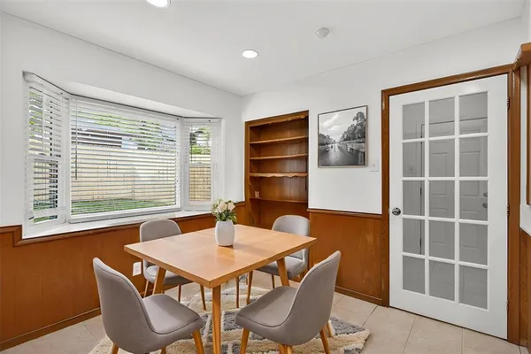 a dining room with furniture and window