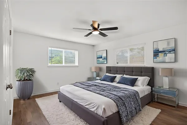 a bedroom with a bed and wooden floor