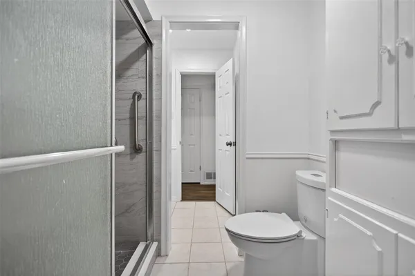 a bathroom with a toilet and a shower