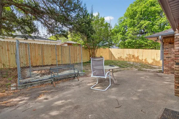a view of backyard with a table and chairs