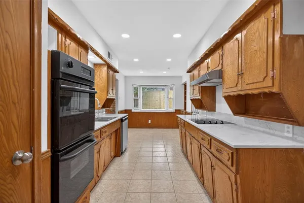 a kitchen with stainless steel appliances granite countertop a sink and cabinets