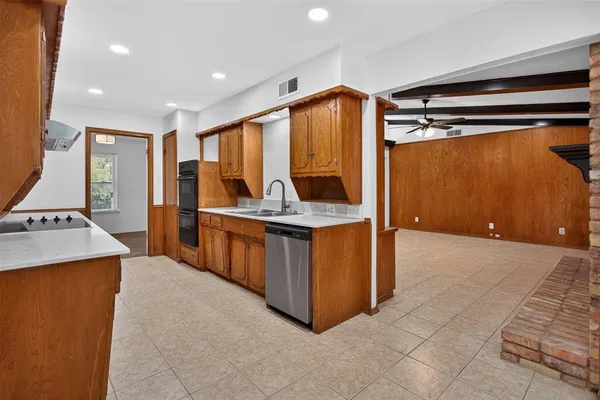a kitchen with stainless steel appliances granite countertop a sink and a refrigerator