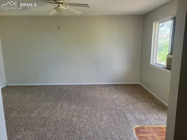 a view of an empty room and a window