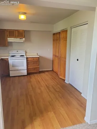 a kitchen with a stove and white cabinets