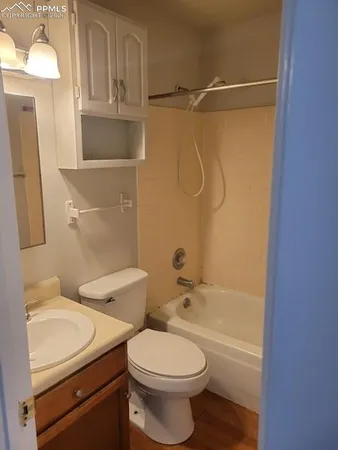 a bathroom with a toilet sink and shower