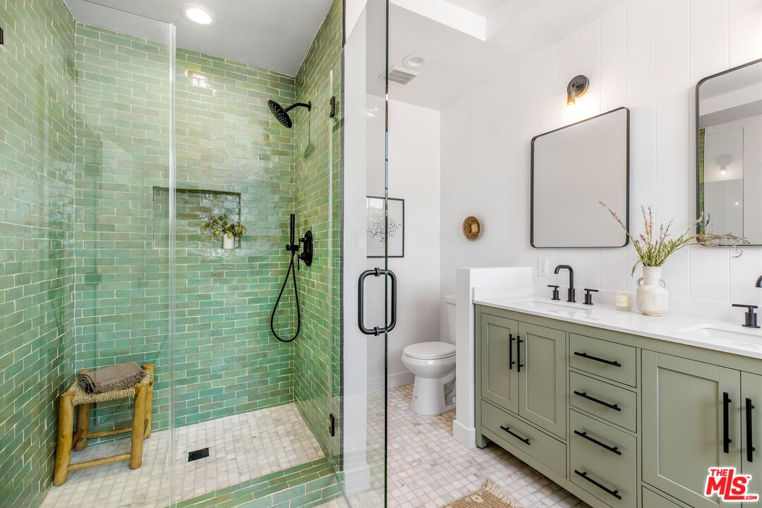 14234 Dickens Street, Unit 2 Sherman Oaks, CA 91423 - Photo 15 of 29 a bathroom with a granite countertop sink a toilet and shower