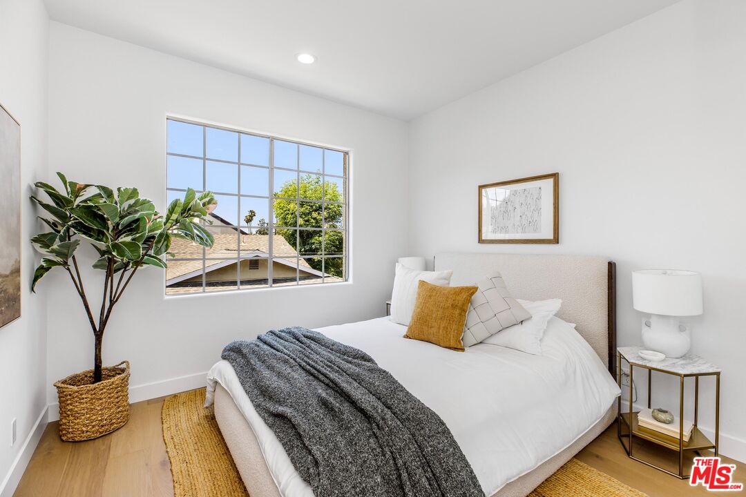 14234 Dickens Street, Unit 2 Sherman Oaks, CA 91423 - Photo 18 of 29 a bedroom with a bed and a potted plant