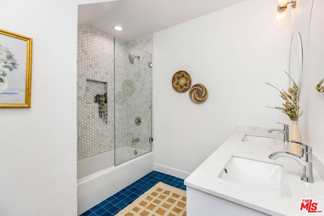 14234 Dickens Street, Unit 2 Sherman Oaks, CA 91423 - Photo 21 of 29 a bathroom with a tub sink and shower curtain