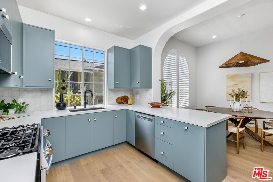 14234 Dickens Street, Unit 2 Sherman Oaks, CA 91423 - Photo 10 of 29 a kitchen with a sink stove and cabinets