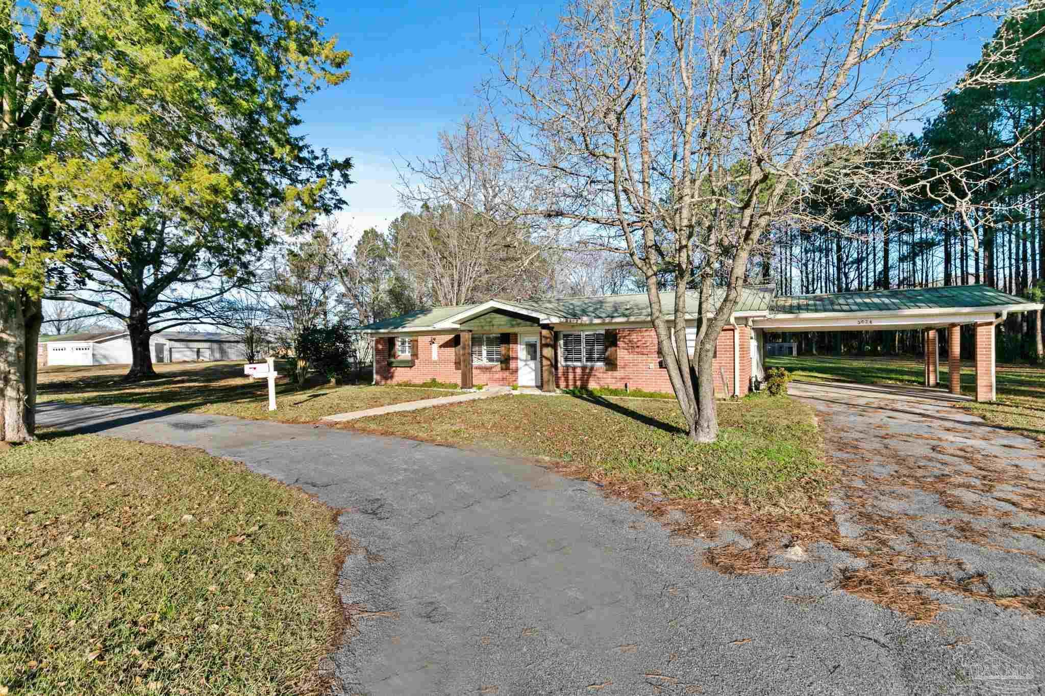 5024 Highway 21 Atmore, AL 36502 - Photo 7 of 38 a front view of a house with a yard and garage