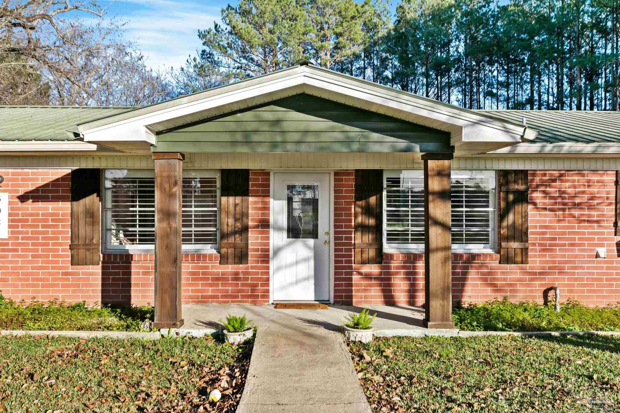 5024 Highway 21 Atmore, AL 36502 - Photo 9 of 38 a front view of a house with garden