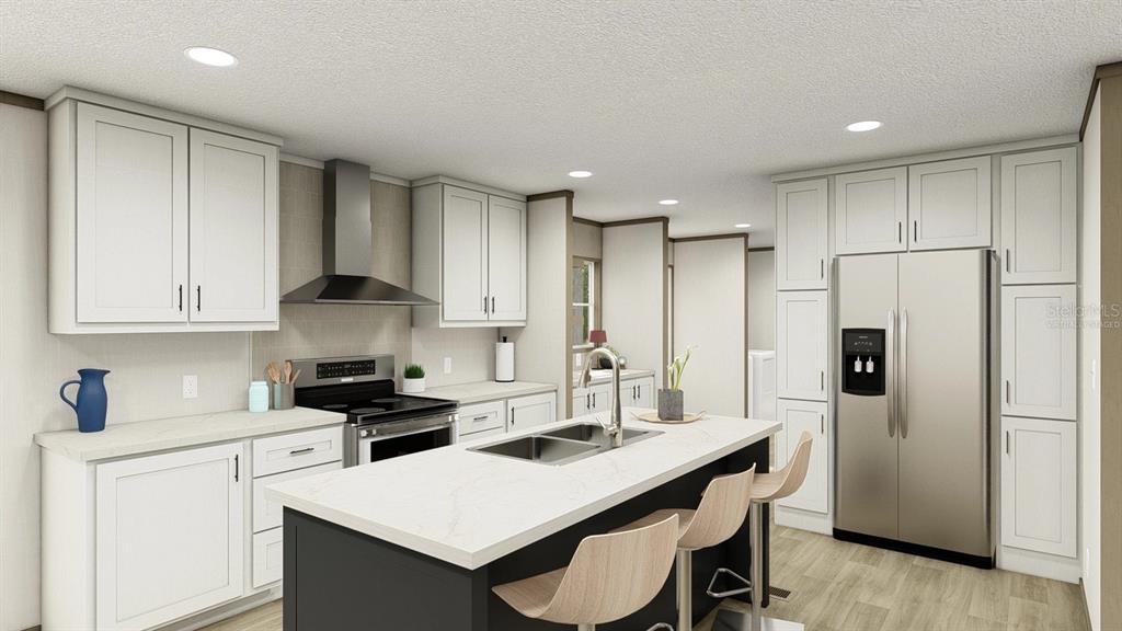 40410 Country Road Eustis, FL 32736 - Photo 4 of 16 a kitchen with a refrigerator a stove a sink and white cabinets