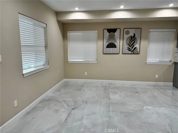a kitchen with granite countertop white cabinets stainless steel appliances and a sink