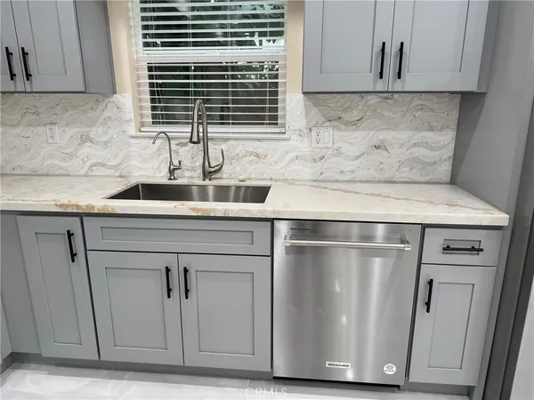 a kitchen with refrigerator and sink