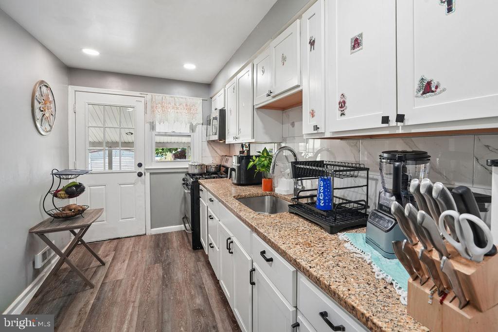 1918 Church Road Baltimore, MD 21222 - Photo 8 of 29 a kitchen with sink cabinets and window
