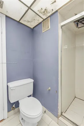 a white toilet sitting next to a bathroom sink
