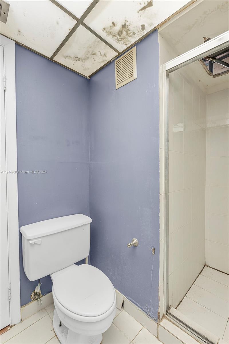 16100 Golf Club Road, Unit 101 Weston, FL 33326 - Photo 14 of 35 a white toilet sitting next to a bathroom sink