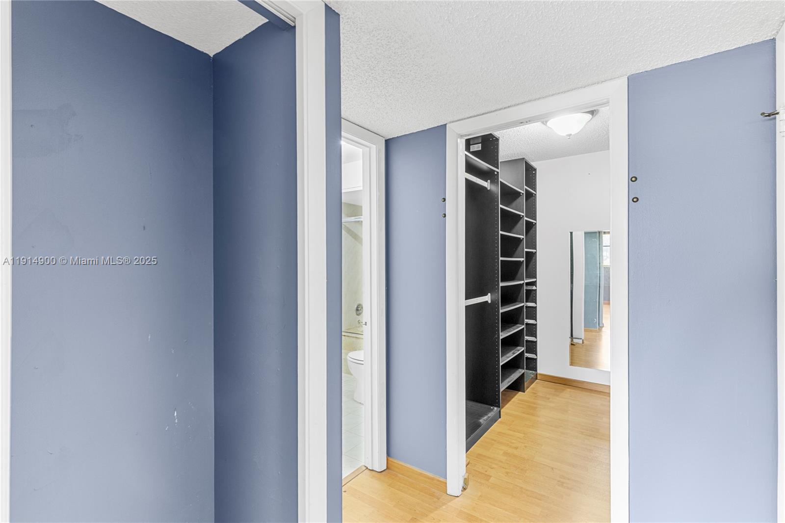 16100 Golf Club Road, Unit 101 Weston, FL 33326 - Photo 20 of 35 a view of walk in closet with clothes