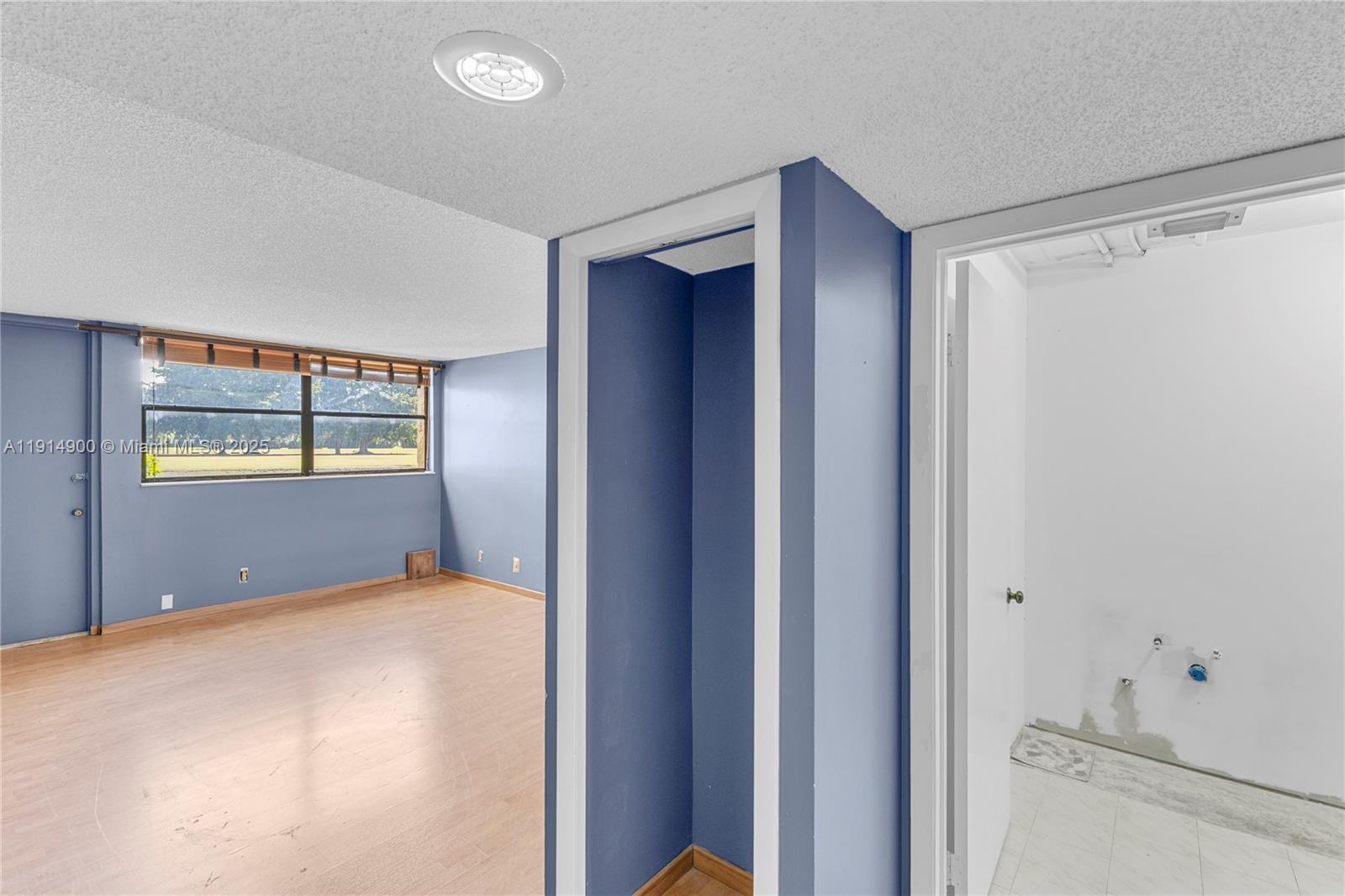 16100 Golf Club Road, Unit 101 Weston, FL 33326 - Photo 23 of 35 a bedroom with window and ceiling fan