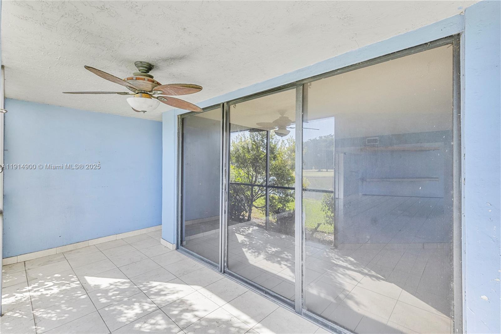 16100 Golf Club Road, Unit 101 Weston, FL 33326 - Photo 25 of 35 a view of a big room with a ceiling fan and window