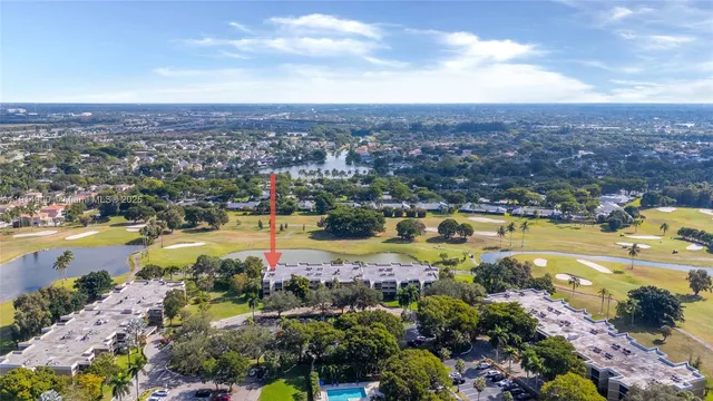 an aerial view of residential houses with outdoor space and swimming pool