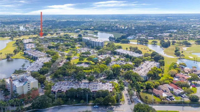an aerial view of residential houses with outdoor space and swimming pool